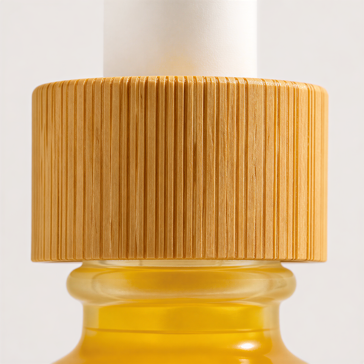 A close-up image of a yellow bottle with a wooden cap, set against a plain white background.